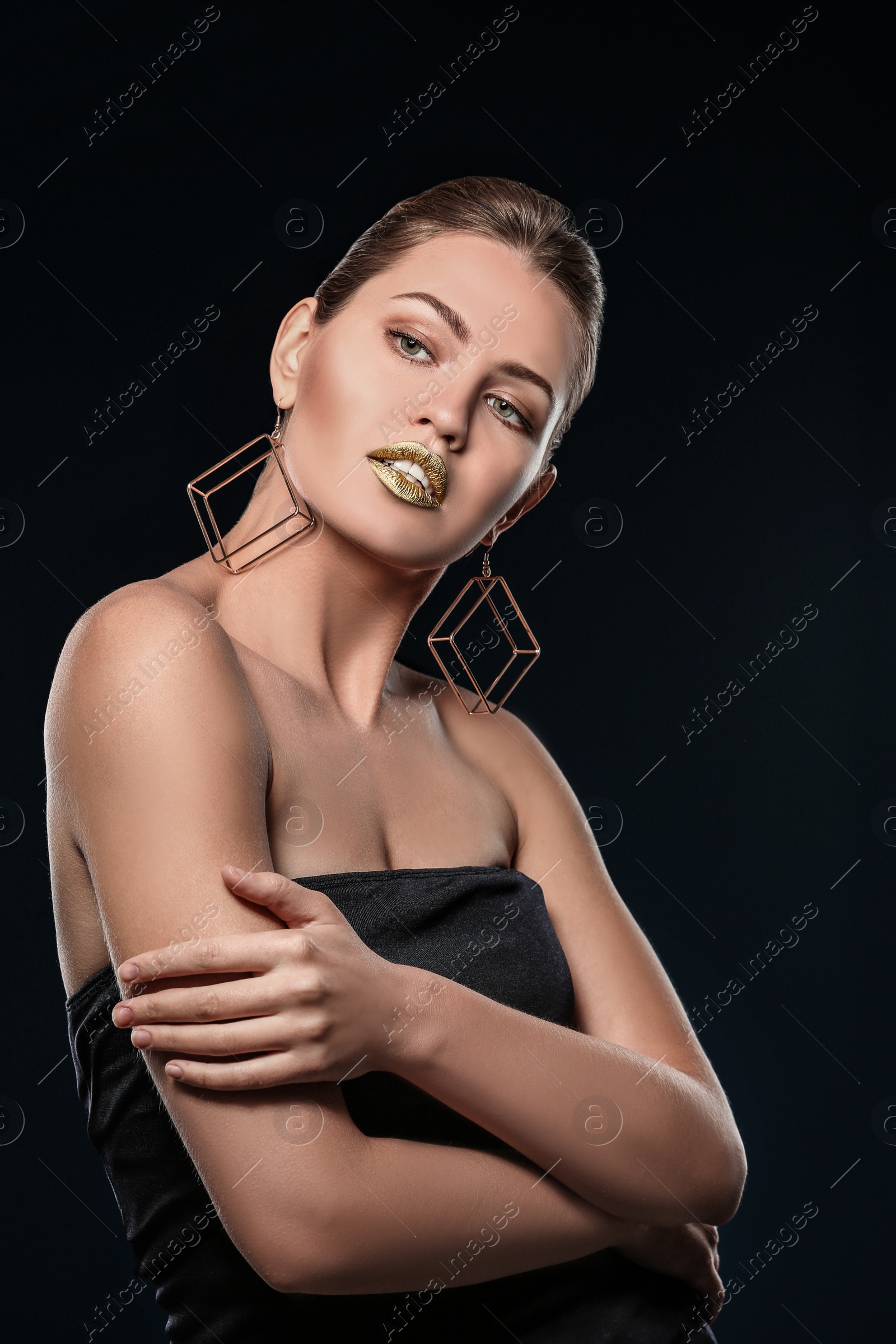 Photo of Portrait of beautiful lady with gold lipstick on black background