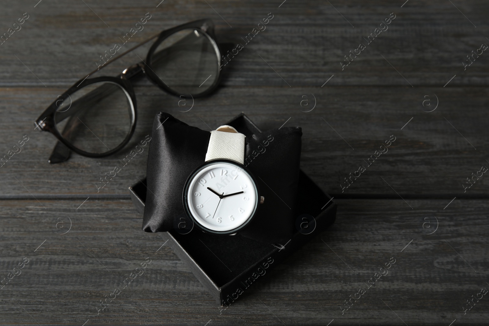 Photo of Composition with stylish wrist watch on wooden background. Fashion accessory