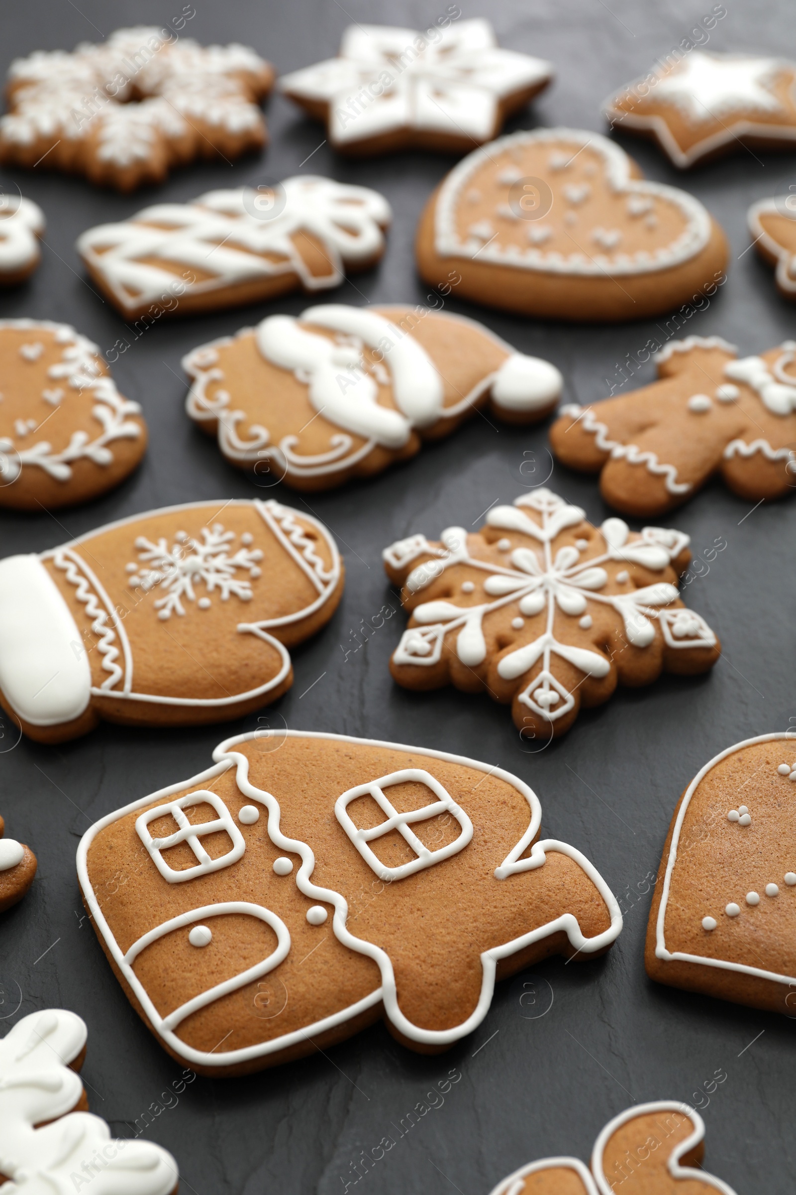 Photo of Many different delicious Christmas cookies on black table