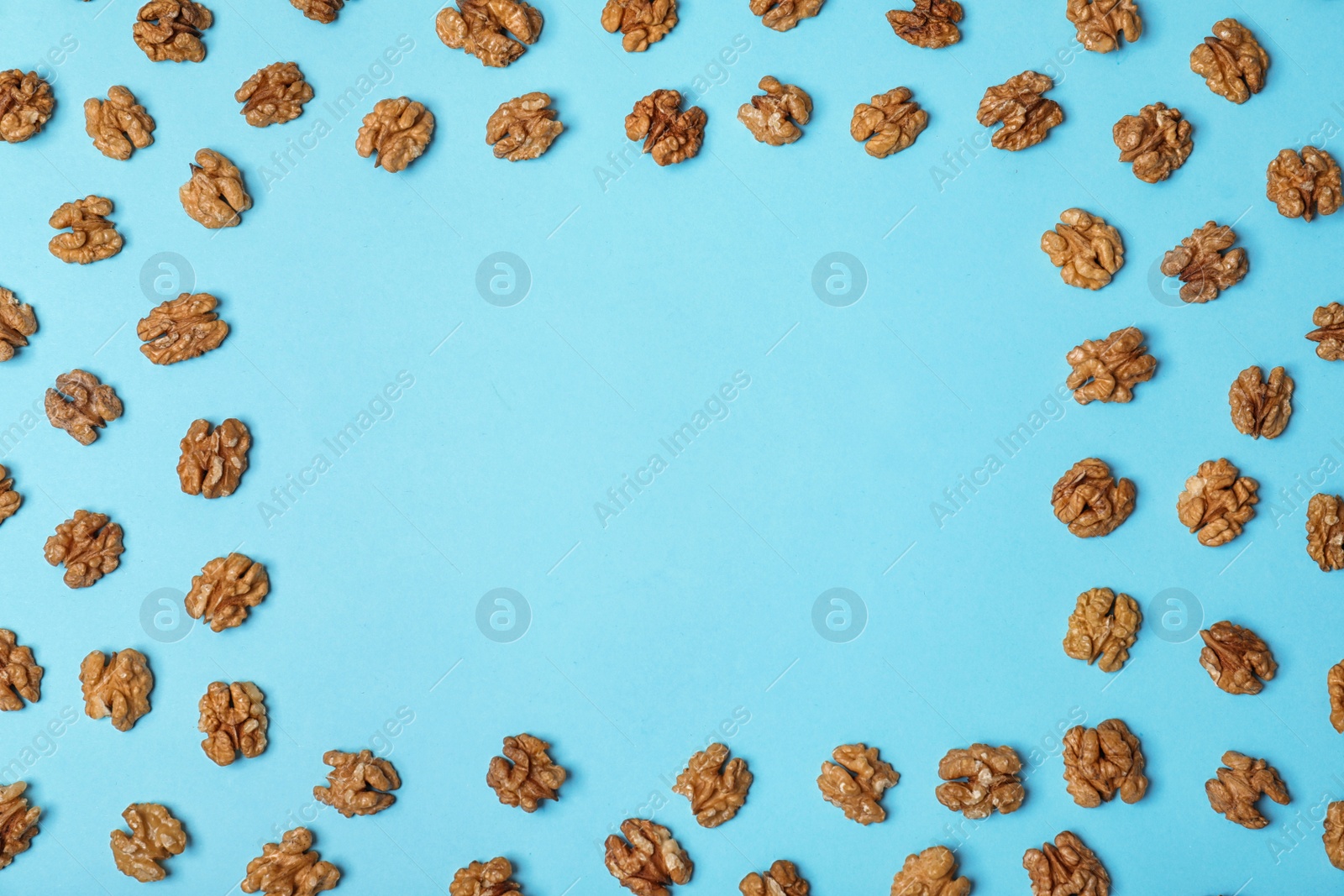 Photo of Flat lay composition with tasty walnuts and space for text on color background