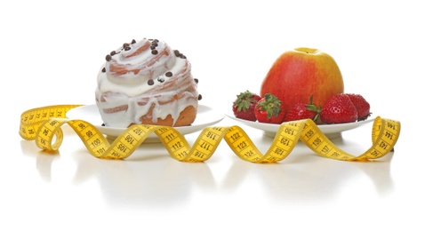 Sweet cake and plate with fresh fruits on white background. Choice between diet and unhealthy food