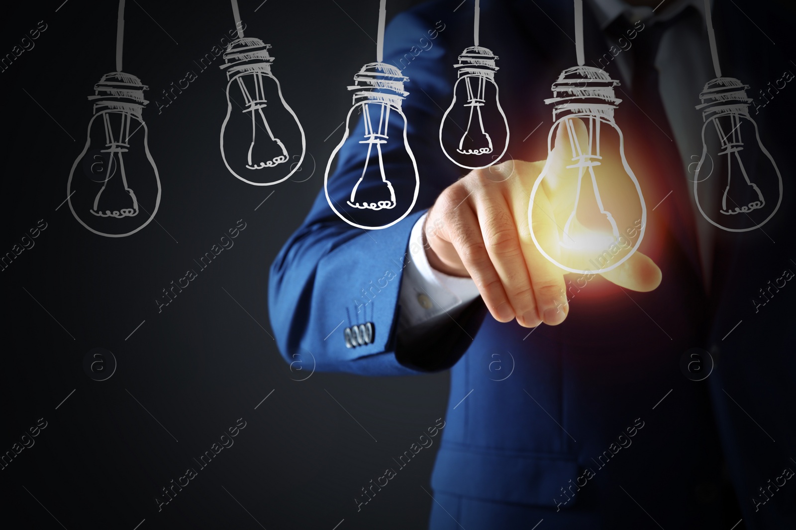 Image of Idea concept. Businessman touching glowing light bulb on virtual screen, closeup