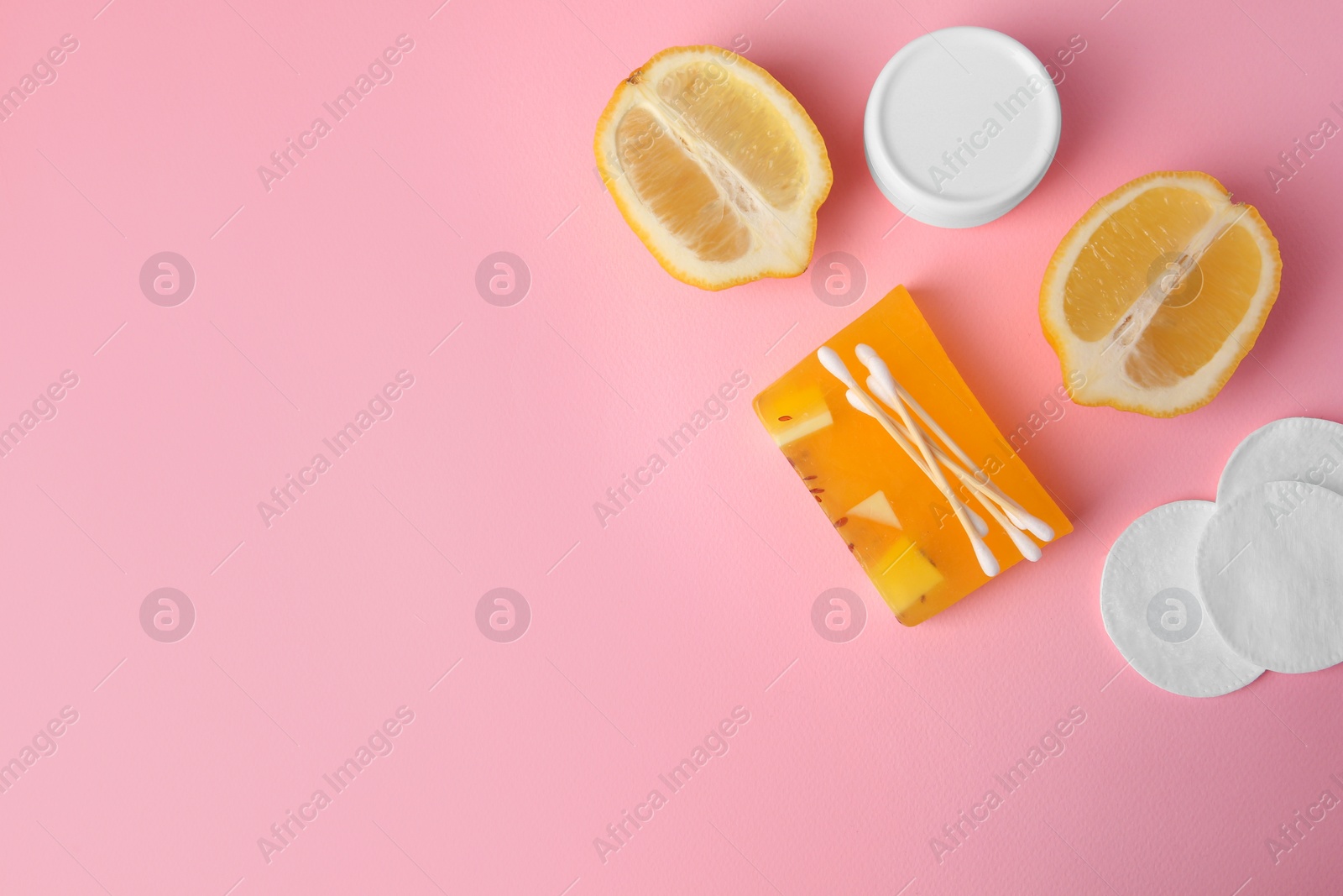 Photo of Lemon face wash. Fresh citrus fruits and personal care products on pink background, flat lay. Space for text