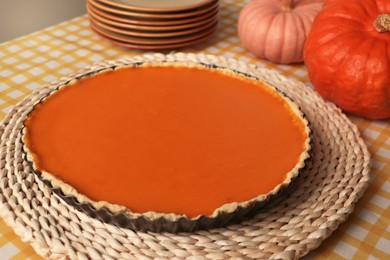 Photo of Delicious homemade pumpkin pie in baking dish on table