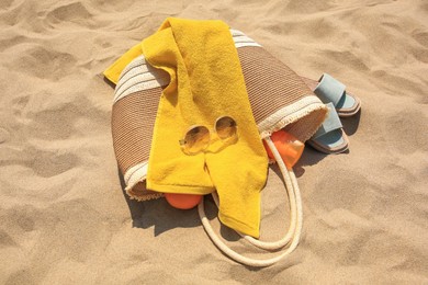 Photo of Beach bag, sunglasses and other accessories on sand, above view