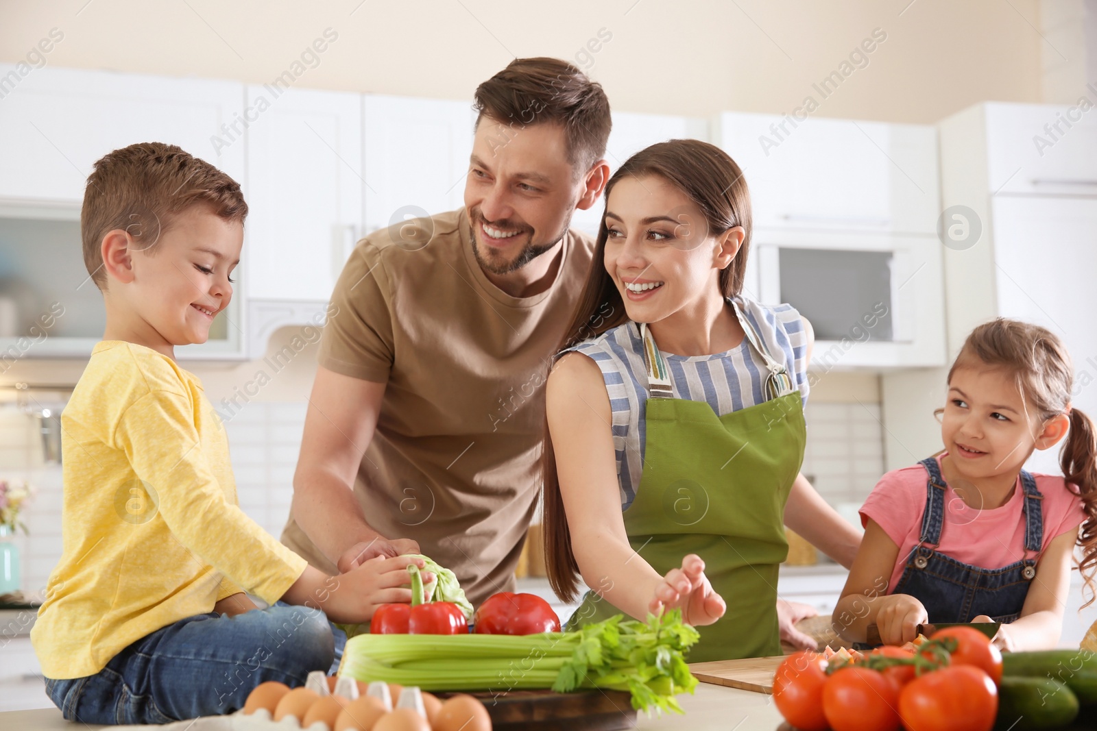 Photo of Happy family with children together in kitchen