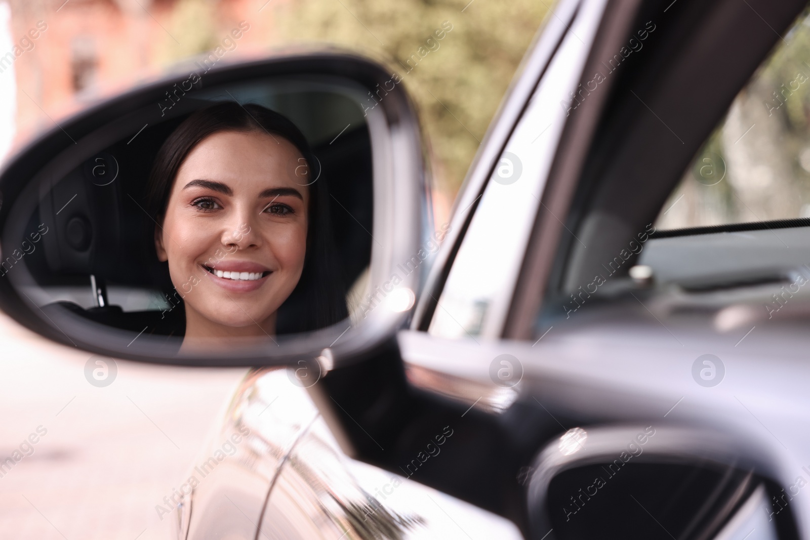 Photo of Woman with safety seat belt driving her modern car