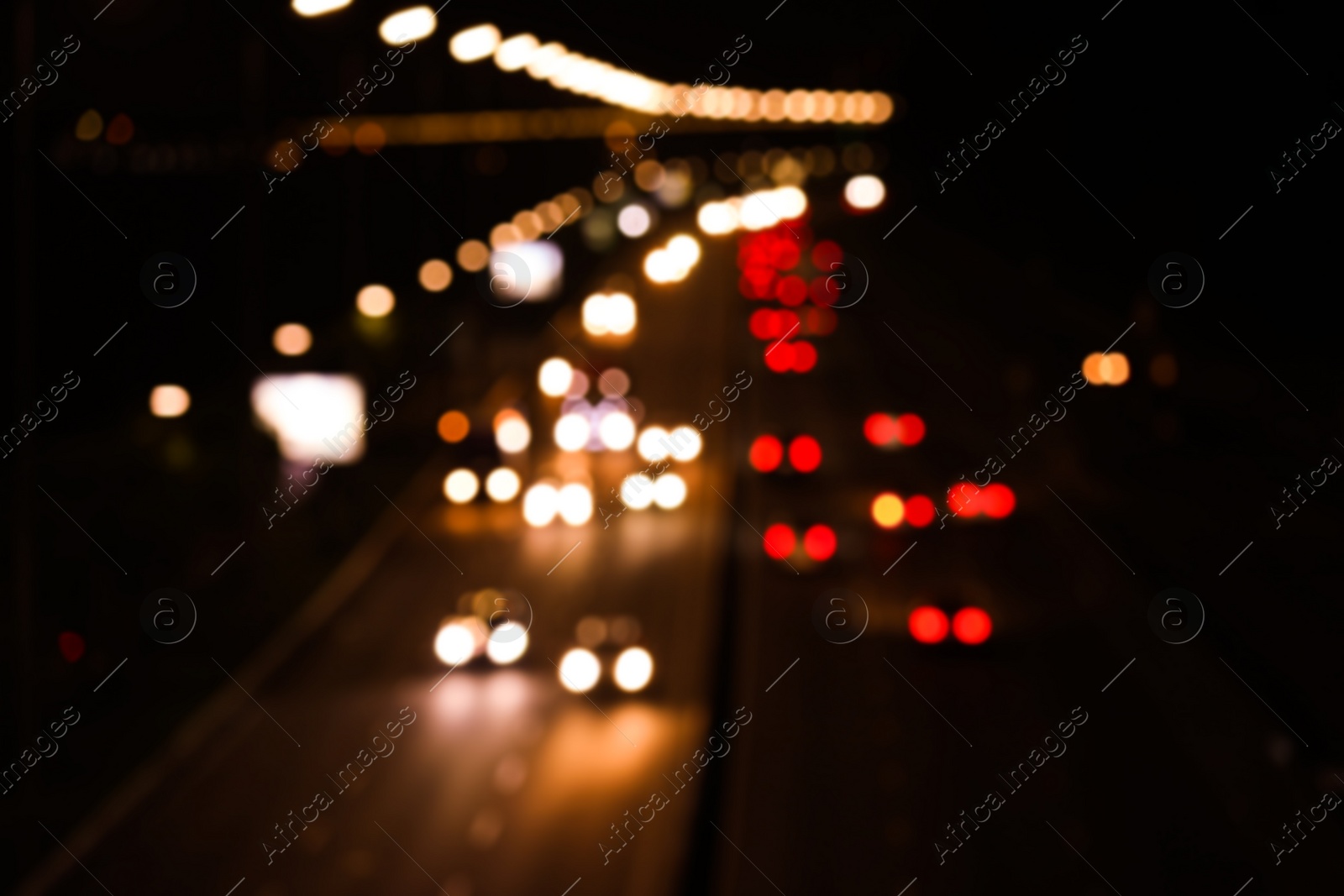 Photo of Blurred view of road with cars, bokeh effect. Night life