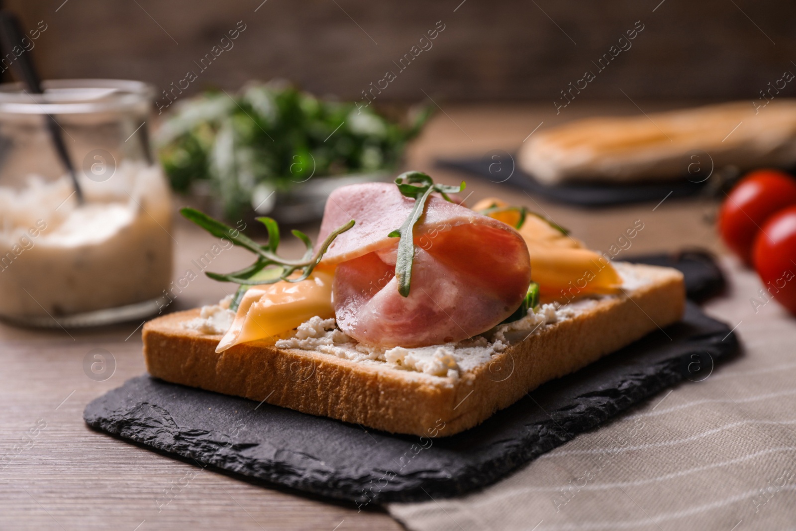 Photo of Delicious sandwich with ham on wooden table