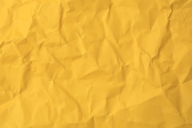 Photo of Sheet of crumpled orange paper as background, top view