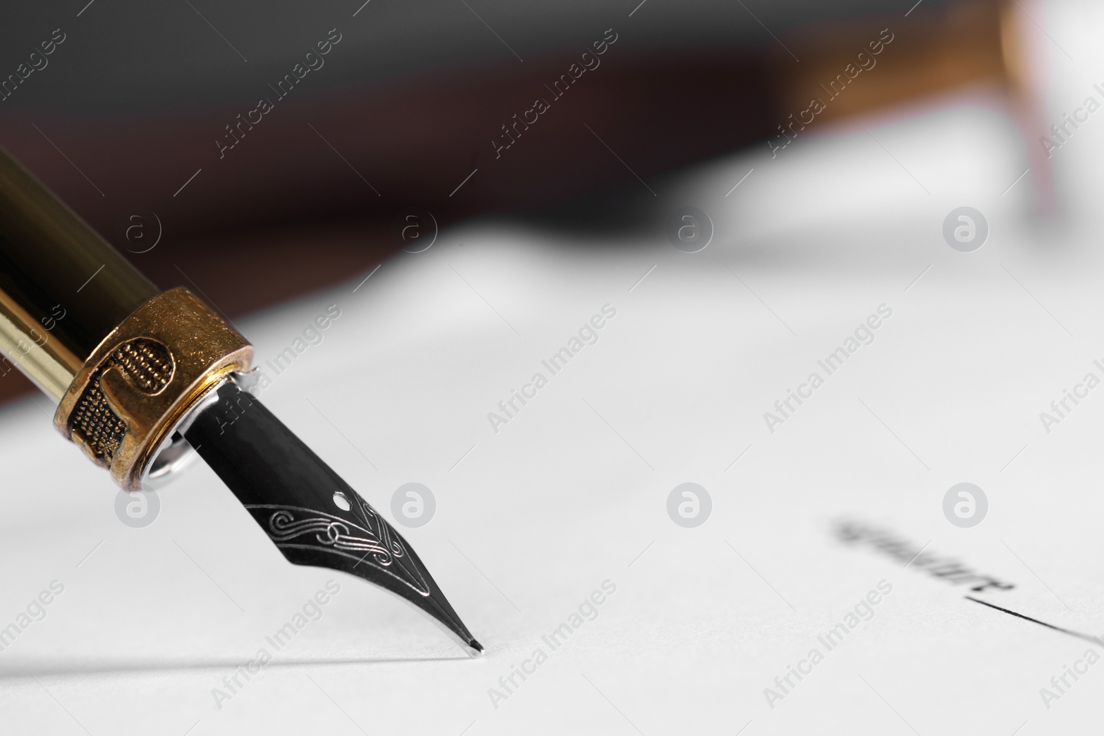 Photo of Writing on document with fountain pen, closeup and space for text. Notary contract