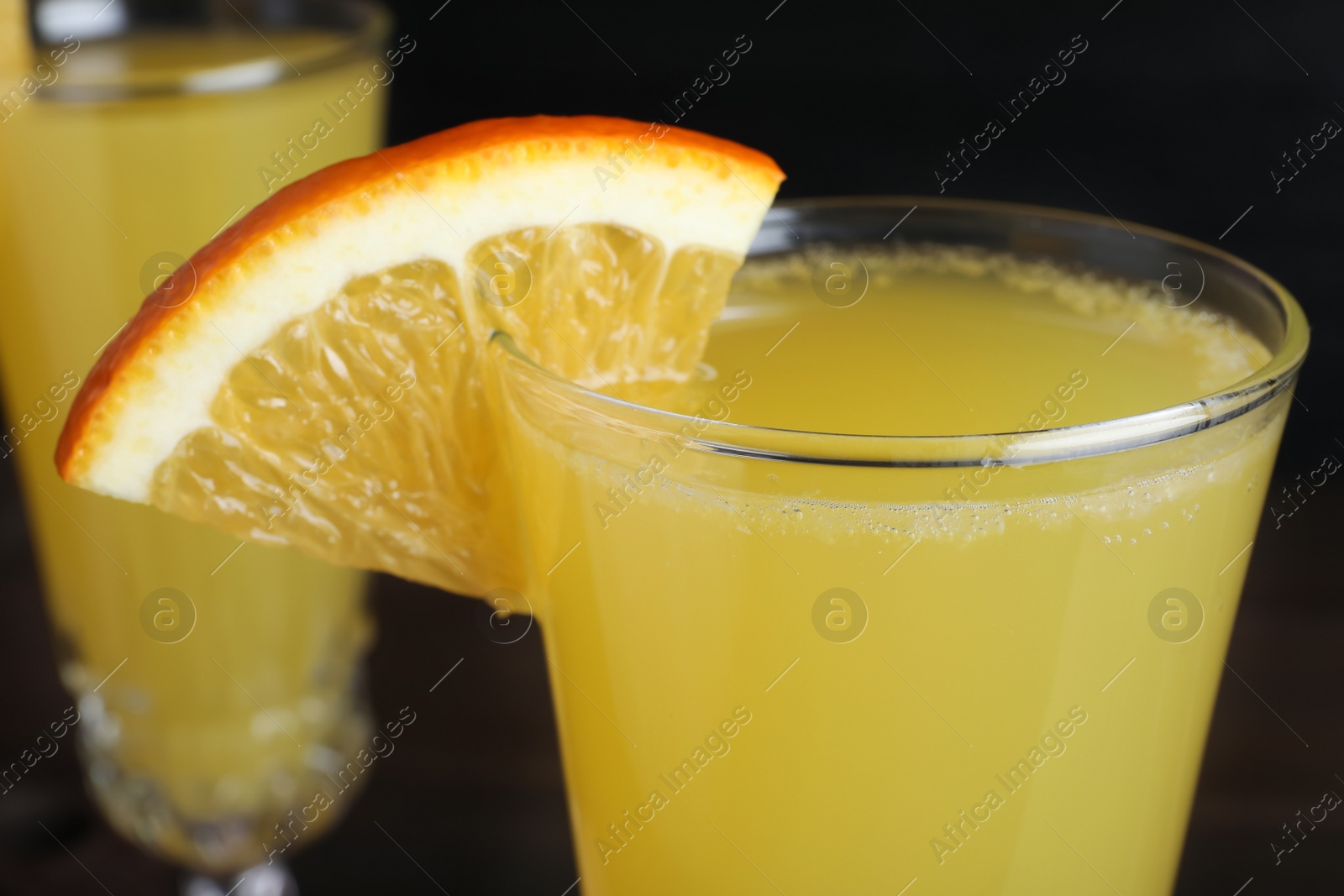 Photo of Glass of Mimosa cocktail with garnish, closeup