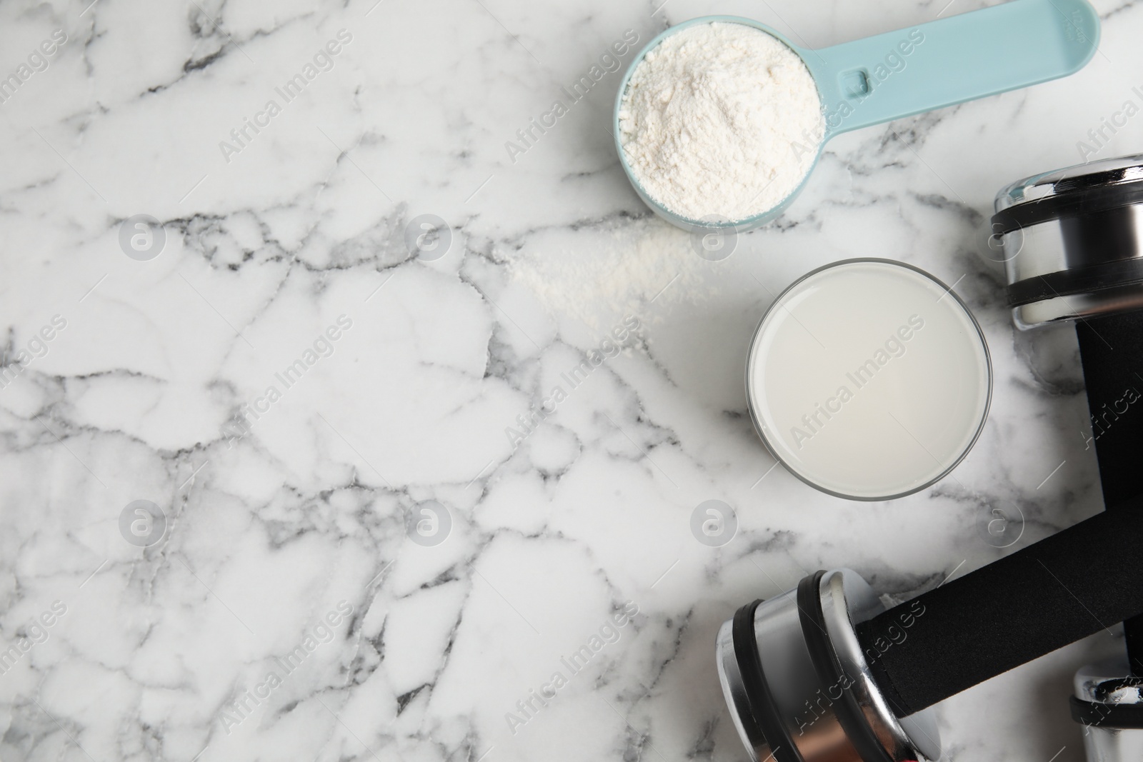 Photo of Amino acid shake, powder and dumbbells on white marble table, flat lay. Space for text