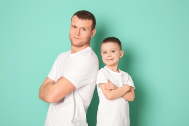 Photo of Dad and his son on color background. Father's day celebration