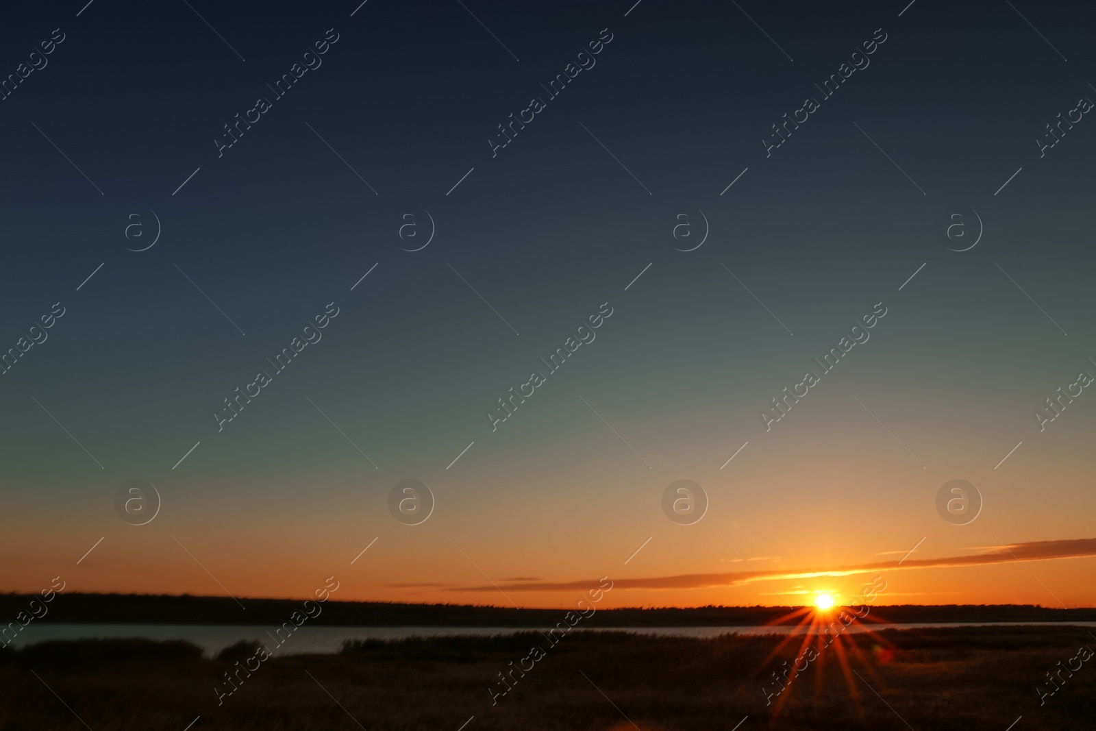 Photo of Picturesque view of beautiful sunrise on riverside. Morning sky