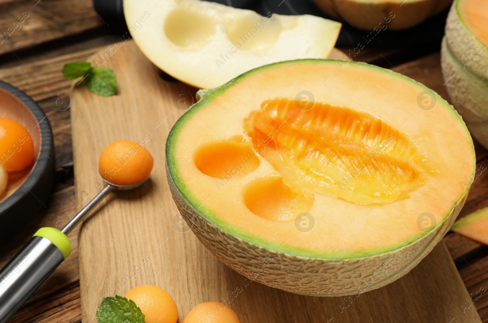 Photo of Composition with melon balls on wooden table