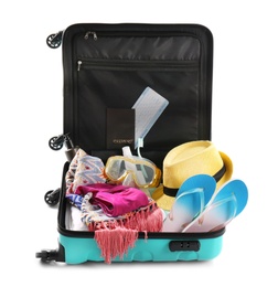 Photo of Packed suitcase with summer clothes and accessories on white background