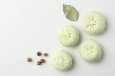 Photo of Composition with raw dumplings, bay leaf and pepper on white background, top view