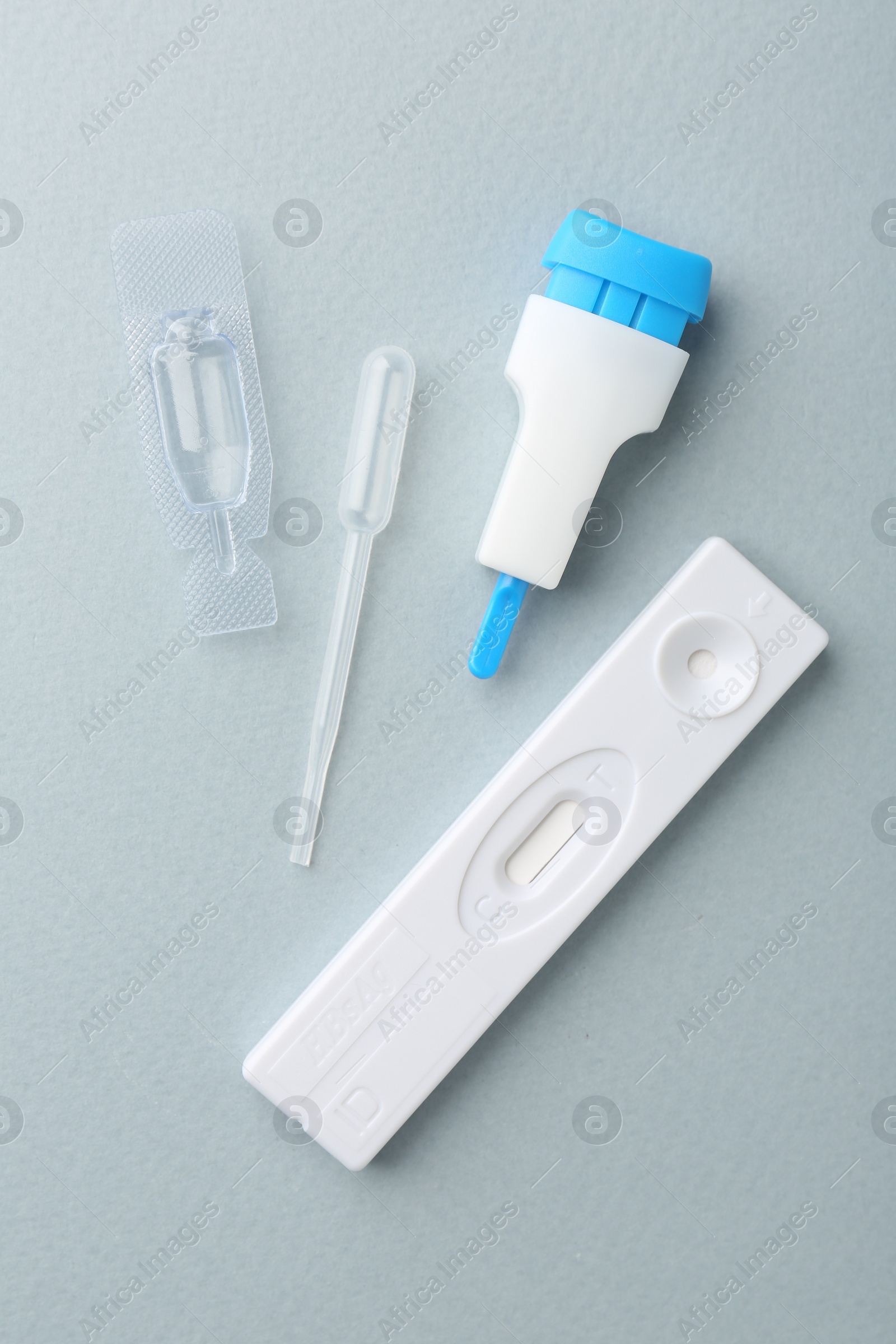 Photo of Disposable express test kit on light blue background, flat lay