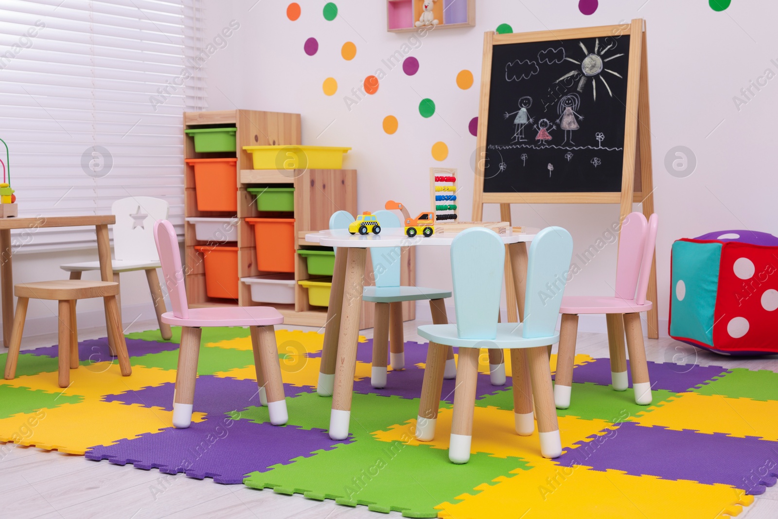 Photo of Stylish kindergarten interior with toys and modern furniture