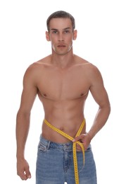 Photo of Handsome shirtless man with slim body and measuring tape around his waist isolated on white
