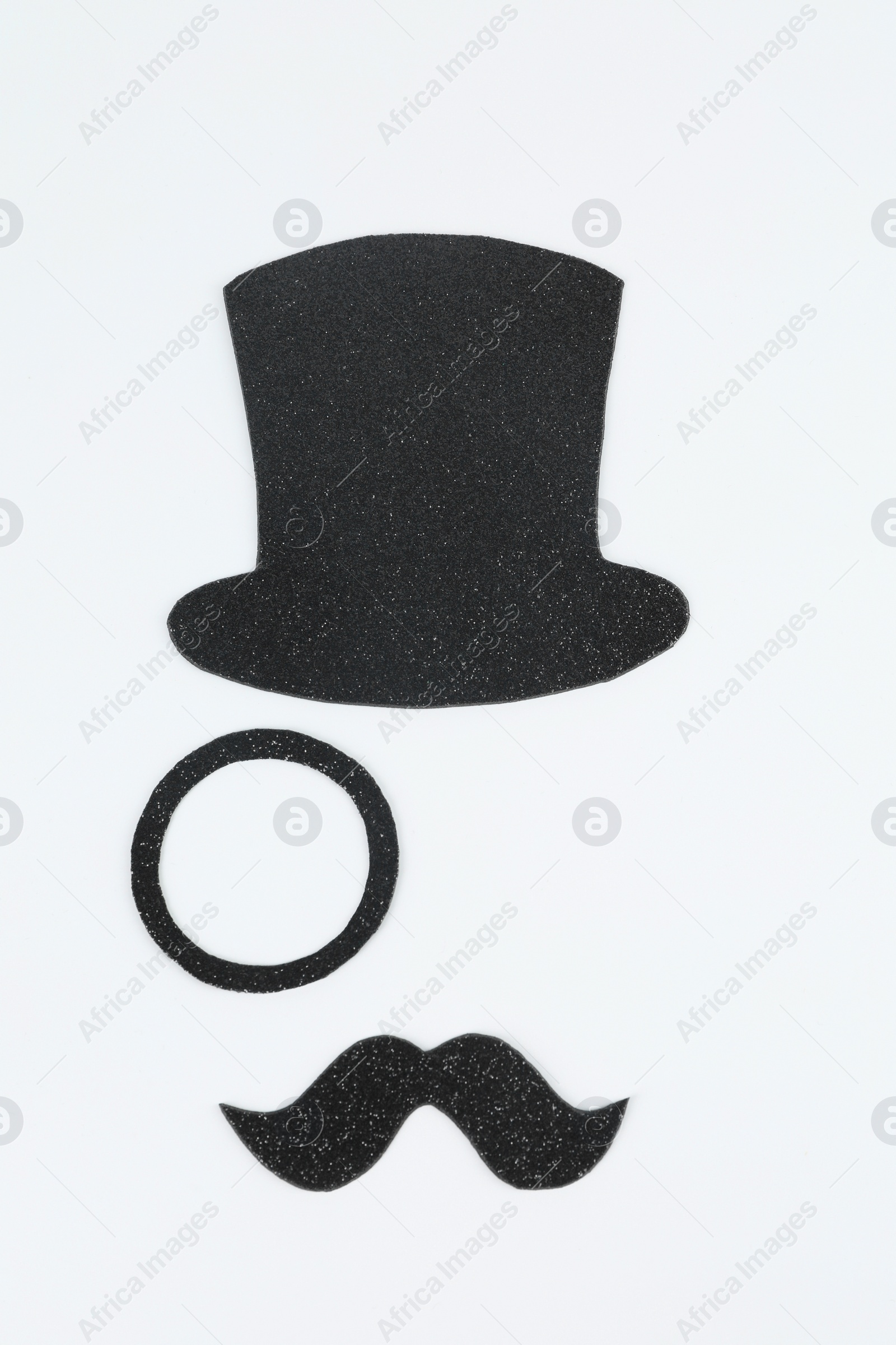 Photo of Fake mustache, hat and monocle on light background, top view