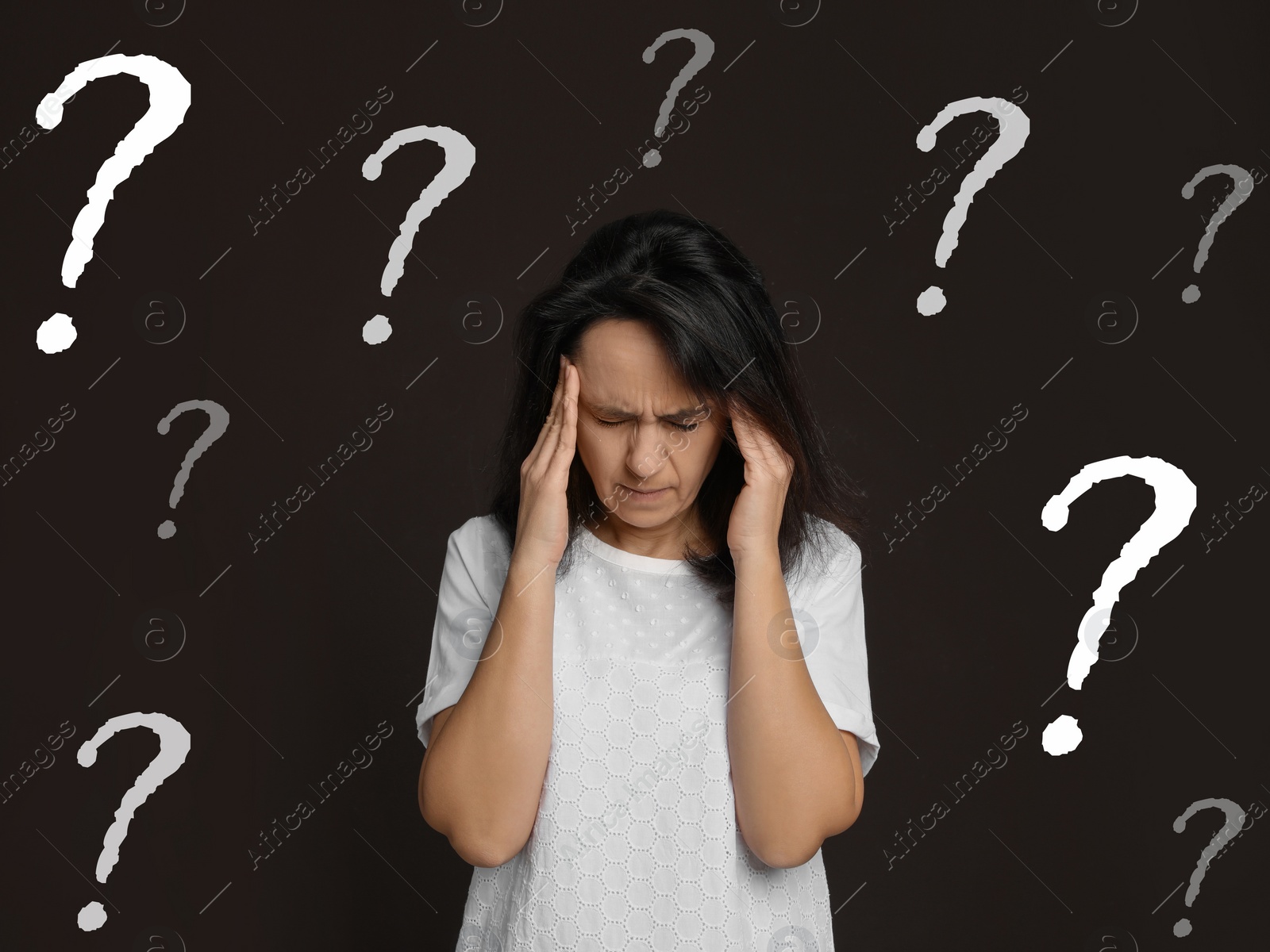 Image of Amnesia. Confused woman and question marks on brown background