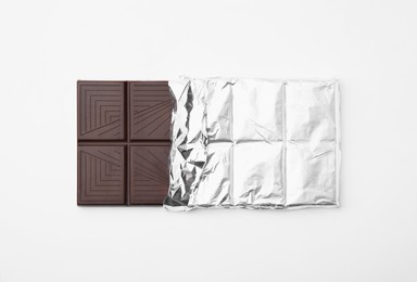 Tasty chocolate bar on white background, top view