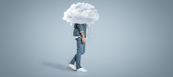 Image of Man with cloud on his head against grey background. Modern storage technology concept