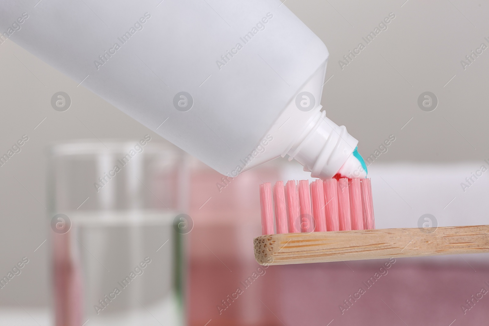 Photo of Applying paste on toothbrush near mouthwash, closeup