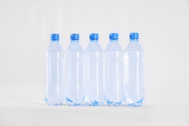 Plastic bottles with pure water on white background