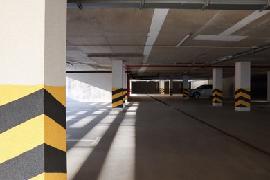 Photo of Open parking garage with car on sunny day