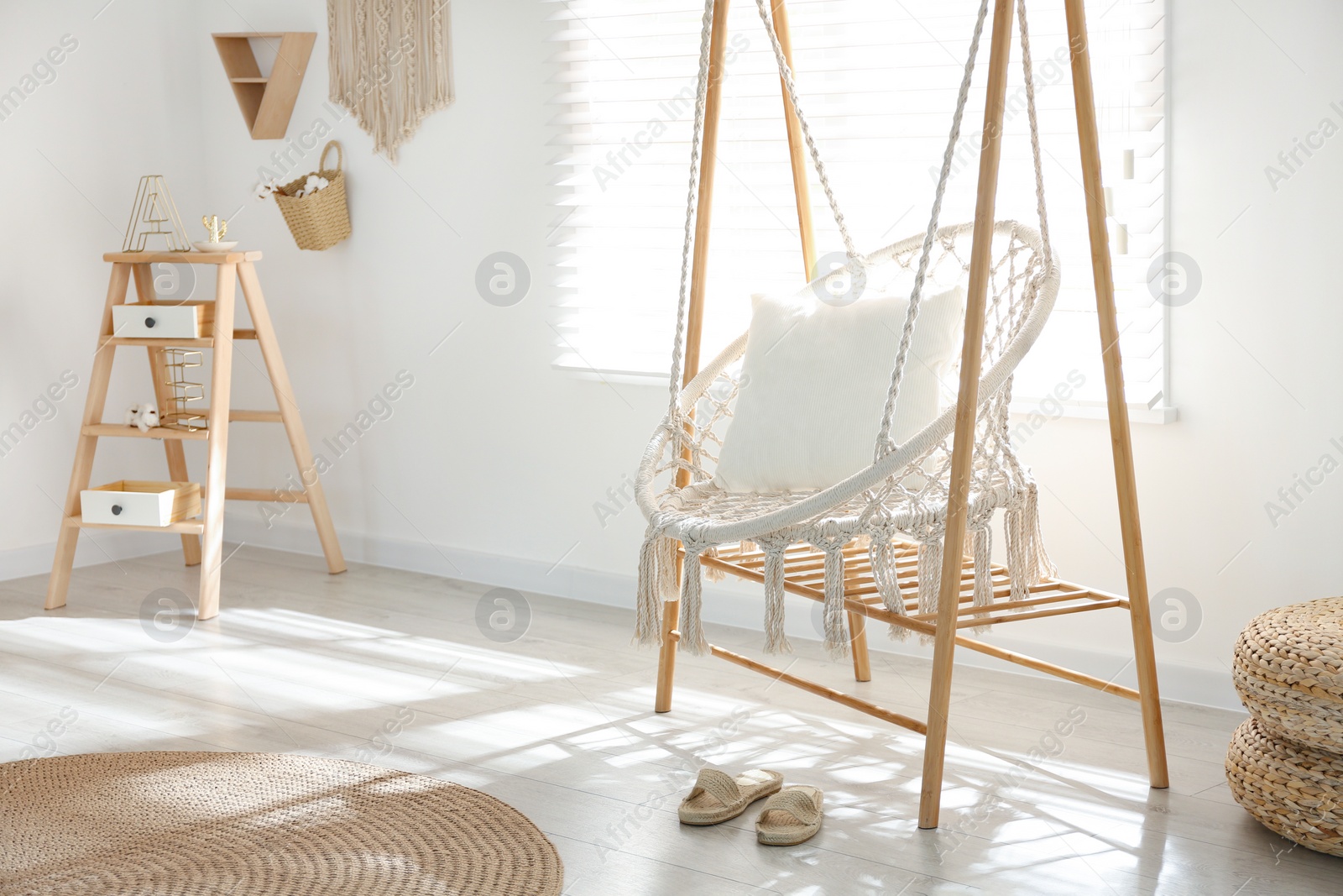 Photo of Comfortable hammock chair in stylish room. Home interior