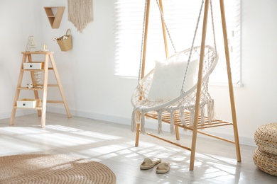 Comfortable hammock chair in stylish room. Home interior