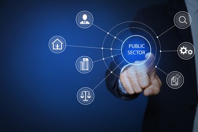 Image of Public Sector concept. Man pointing at virtual screen with different icons on blue background, closeup