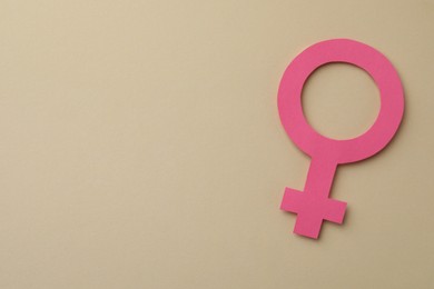 Photo of Female gender sign and space for text on beige background, top view. Women's health concept