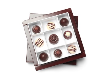 Delicious chocolate candies in box on white background, top view