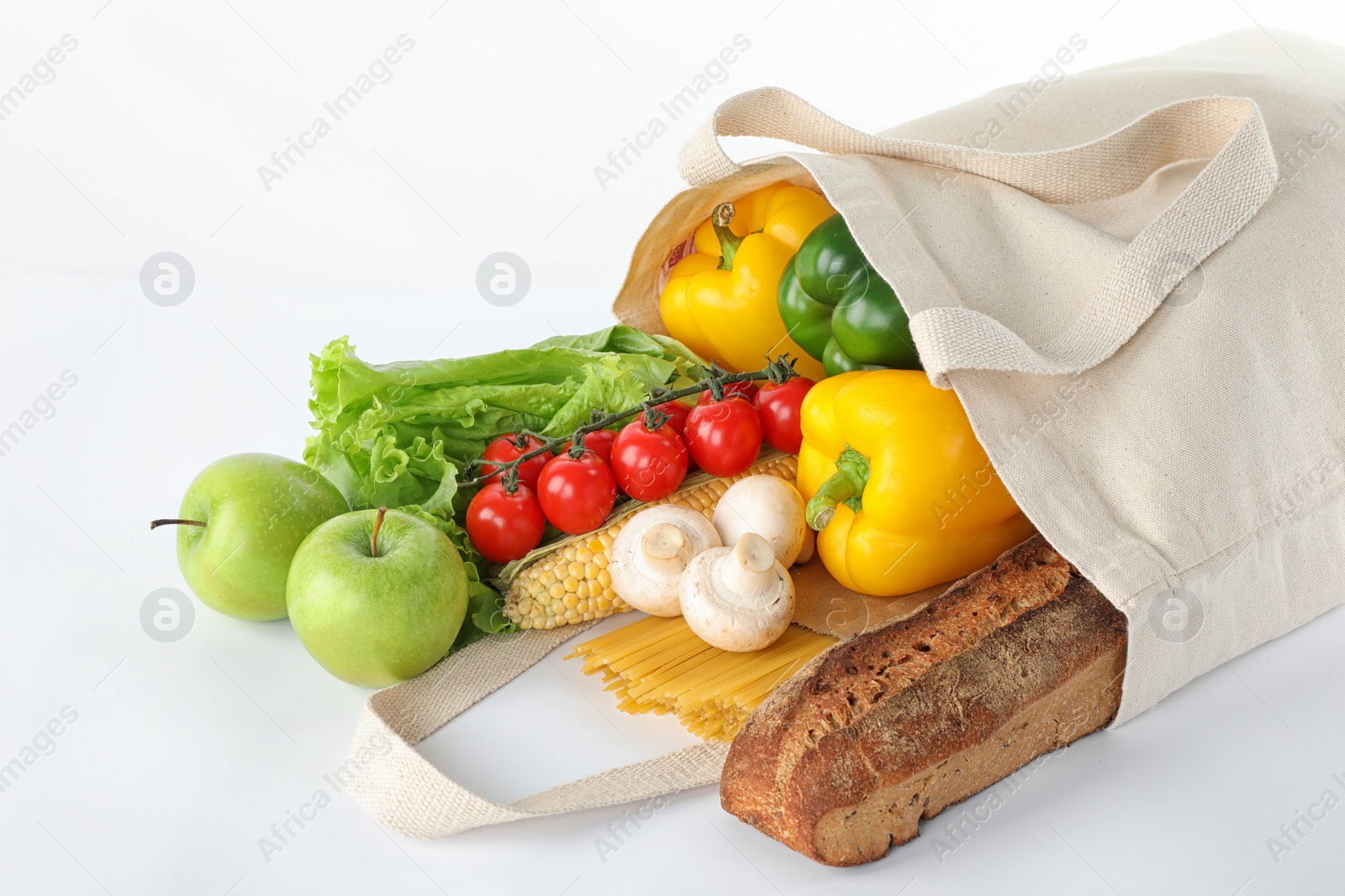 Photo of Different fresh vegetables and fruits in tote bag on white background