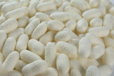 Photo of Pile of natural silkworm cocoons as background, closeup