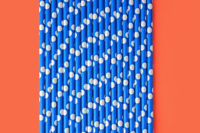 Photo of Many paper drinking straws on orange background, flat lay