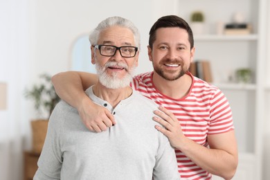 Photo of Happy son and his dad at home