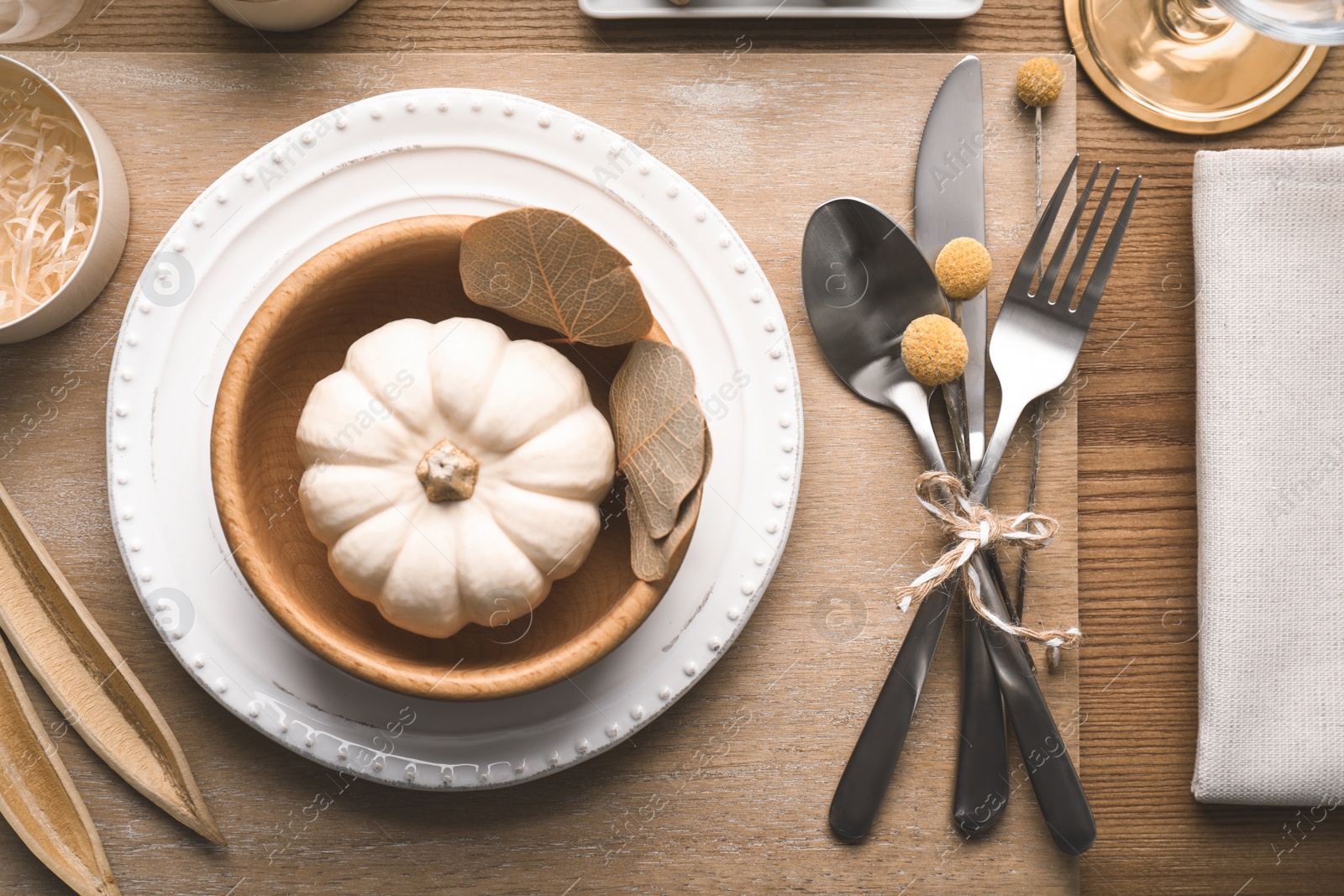 Photo of Autumn table setting with pumpkin and decor on wooden background, flat lay