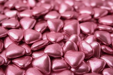 Photo of Many delicious heart shaped candies as background, closeup