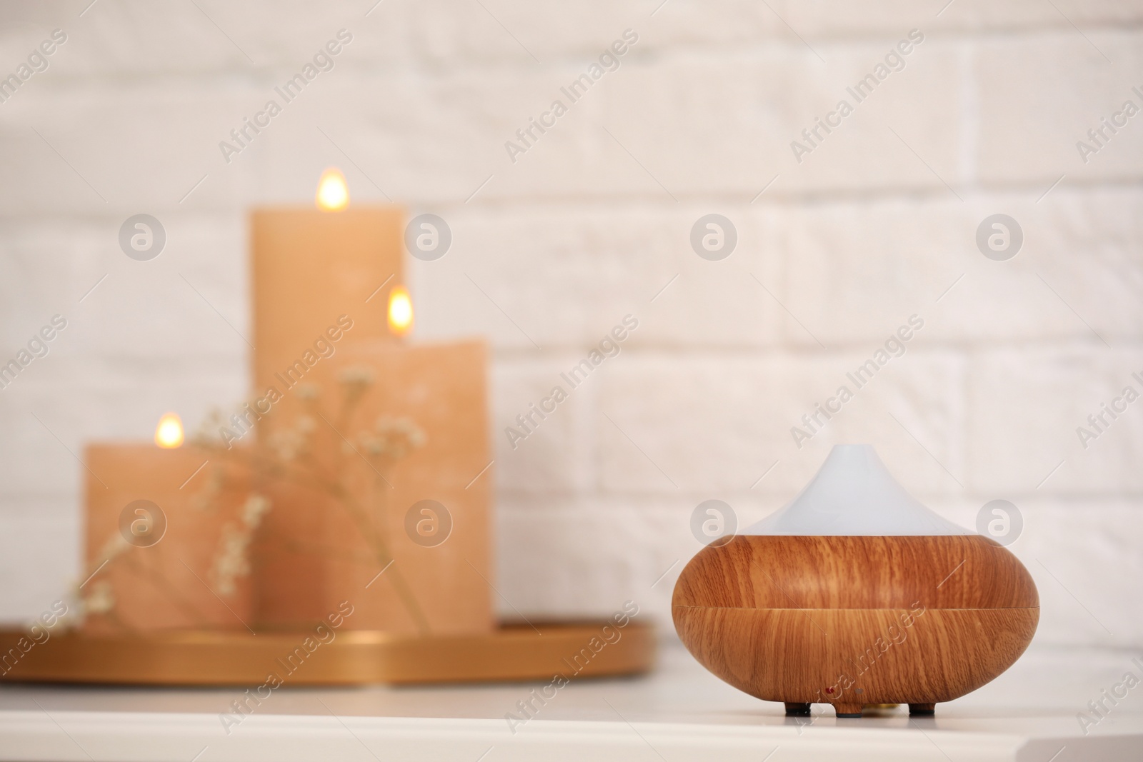 Photo of Modern essential oil diffuser on table indoors