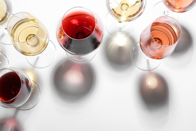 Photo of Different glasses with wine on white background, top view