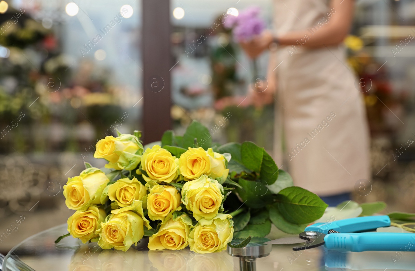 Photo of Beautiful bouquet on table in flower shop. Florist's workplace