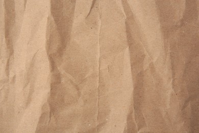 Sheet of crumpled kraft paper as background, top view