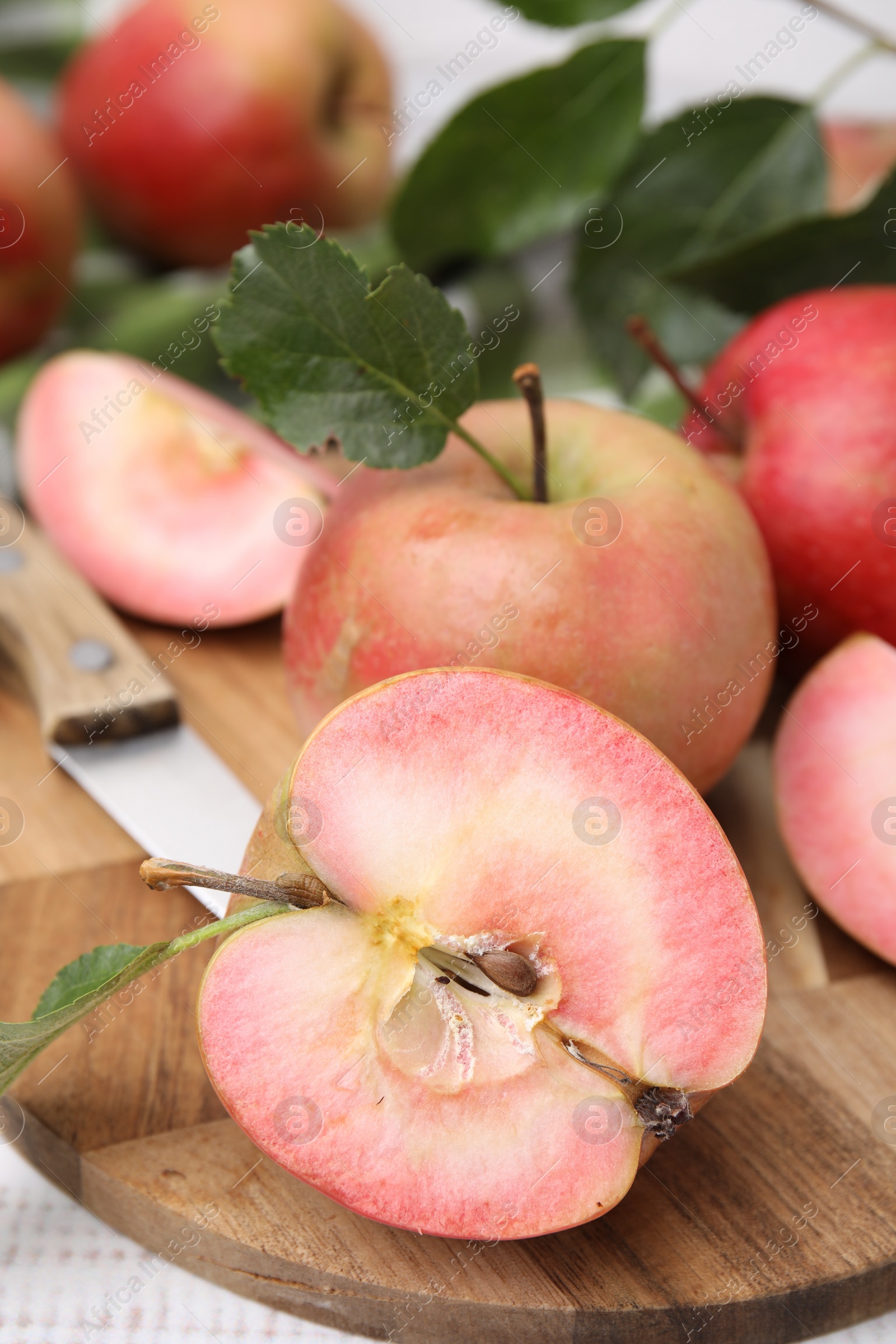 Photo of Tasty apples with red pulp on white wooden table, closeup