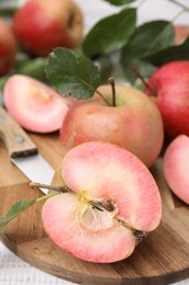 Photo of Tasty apples with red pulp on white wooden table, closeup