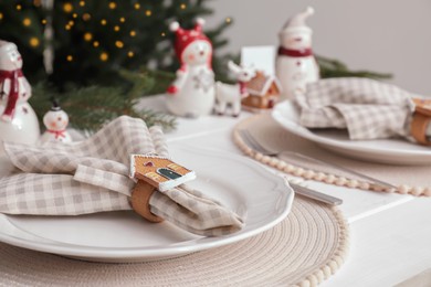 Beautiful festive place setting with stylish decor for Christmas dinner on white wooden table, closeup. Space for text